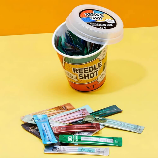 Opened VT Reedle Shot Multiverse Kit with colorful 1ml Reedle Shot sachets displayed beside the container on a yellow background.